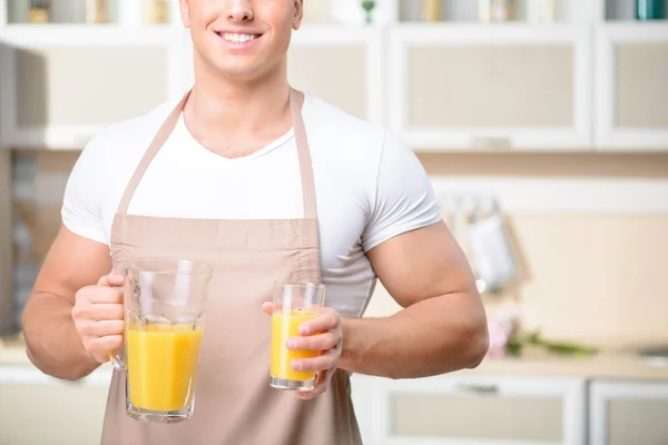 Macho segurando um copo de suco . — Fotografia de Stock