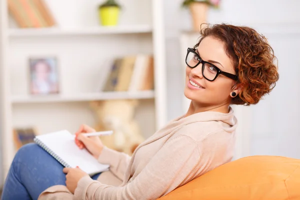 Nice girl resting in arm chair Stock Photo