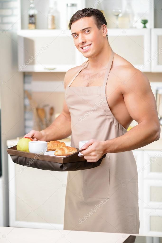 man carrying a tray of breakfast.