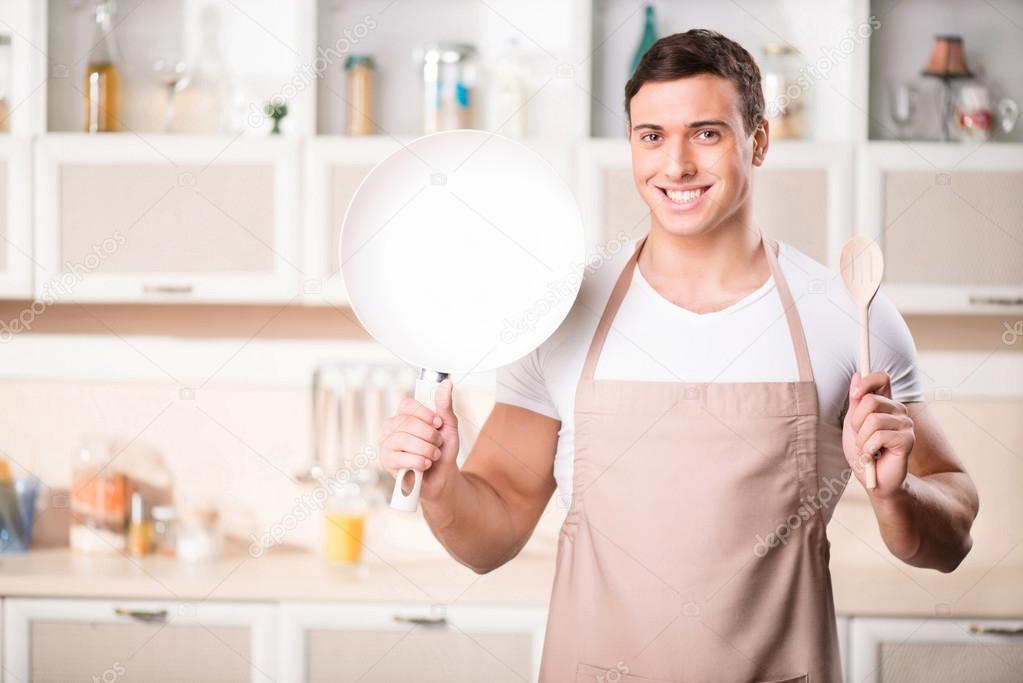 Young attractive cook with frying pan