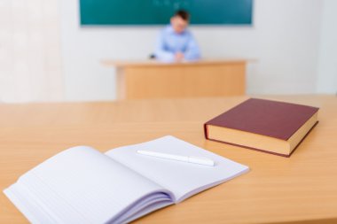 Study manuals are resting on the desk.