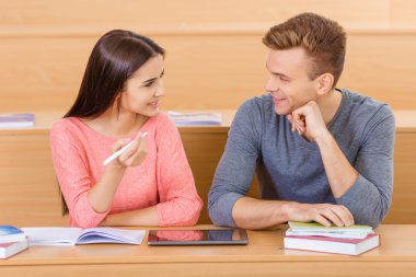 Young student is chatting with her classmate.