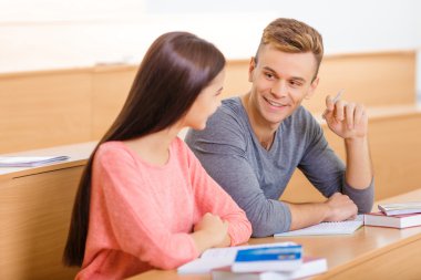 Young student is chatting with his classmate.