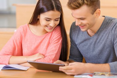 Two college students are working with tablet.