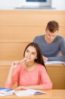 Attractive student girl deep in thoughts.