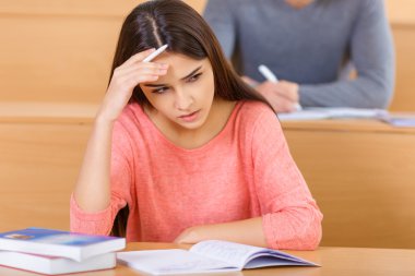 Attractive student girl looks concerned.