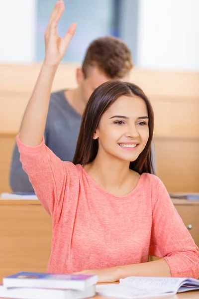 Smiling student wants to answer the question.