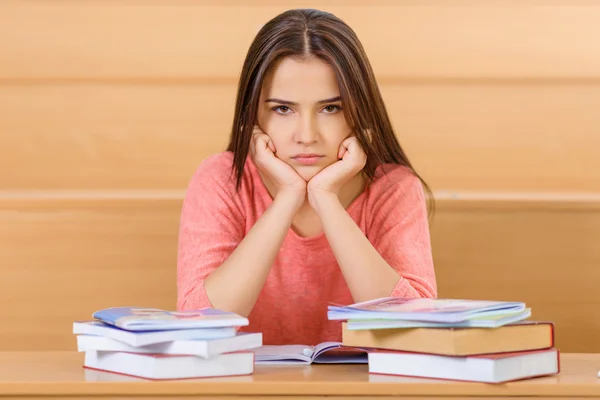 Young student loaded with books and manuals. ロイヤリティフリーのストック画像