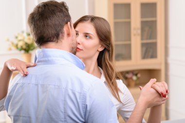 Handsome man commiting betrayal with housemaid