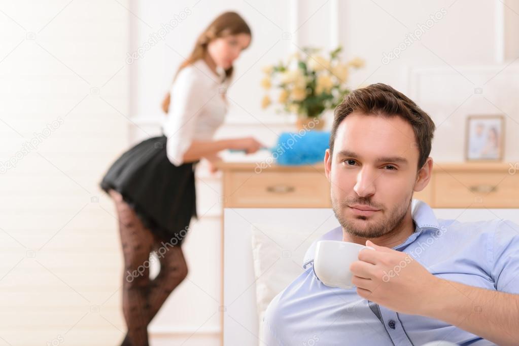 Handsome man commiting betrayal with housemaid
