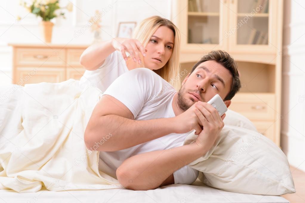 Husband and wife lying in bed