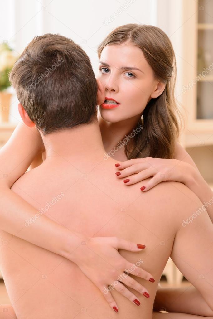 Attractive nude  woman embracing with man