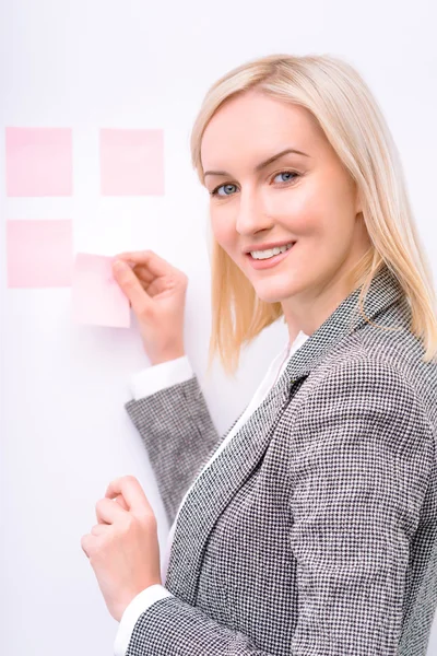 Pleasant businesswoman working with stickers — Stock Photo, Image