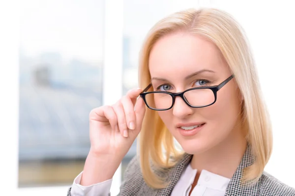 Nice businesswoman holding her glasses — Stock fotografie