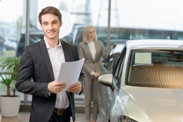 Salesman is holding papers for his client. — Stock Fotó