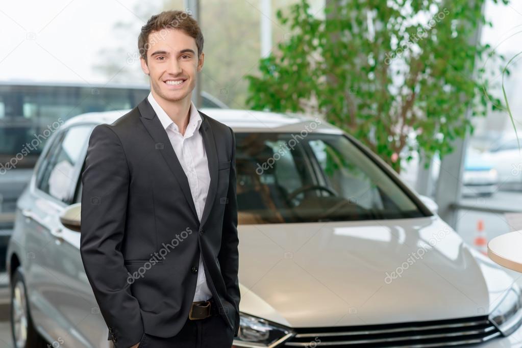 Customer is standing in front of a car.