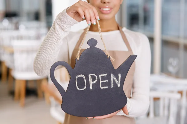 Waitress holding an opening sign. — Stock Photo, Image