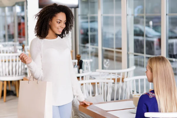 Mujer joven se encuentra con su amigo en el restaurante . — Foto de Stock