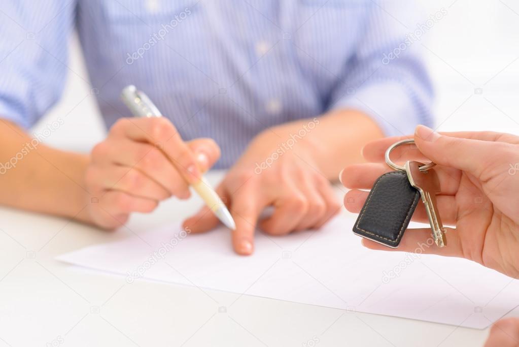 Receptionist helping to fill out the forms.