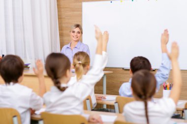 Female teacher with her pupils in the classroom.