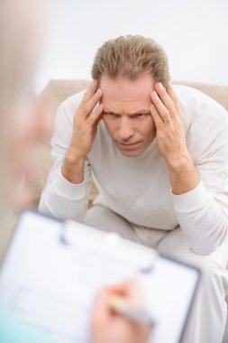 Senior man speaking with psychologist