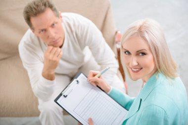 Senior man speaking with psychologist
