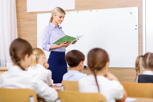 Teacher is busy reading out loud. — 스톡 사진