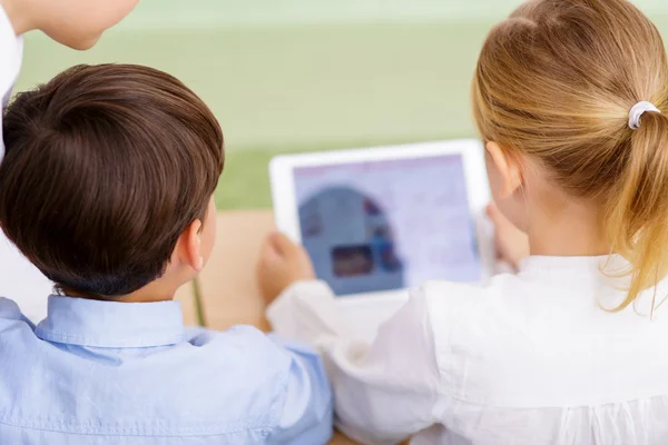Children using portable tablet.