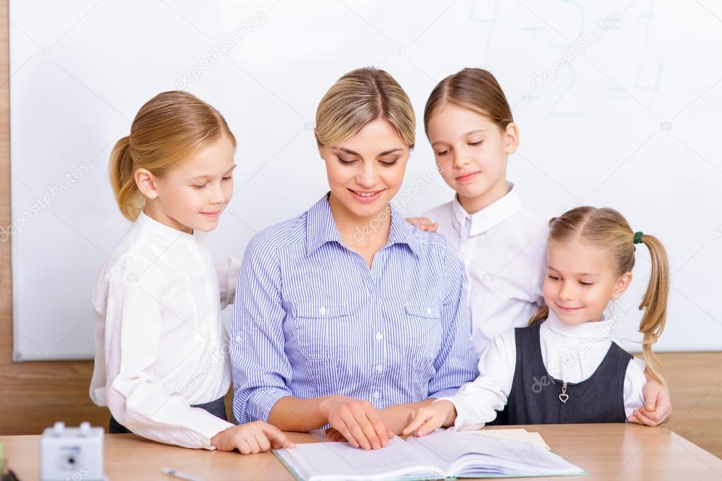 Teacher surrounded by her pupils.