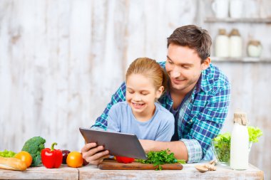 Happy father and daughter cooking together