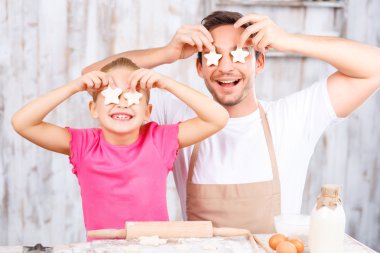Happy daughter and father baking