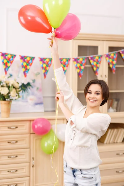 Молода дівчина з різнокольоровими кульками — стокове фото