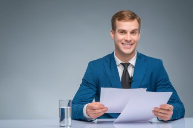 Smiling newscaster during broadcasting. clipart