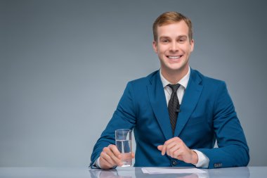 Smiling newscaster during broadcasting. clipart
