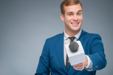 Smiling newsman taking an interview. clipart