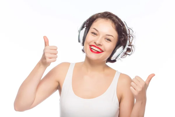 Woman in headphones showing thumbs up. — Stock Photo, Image