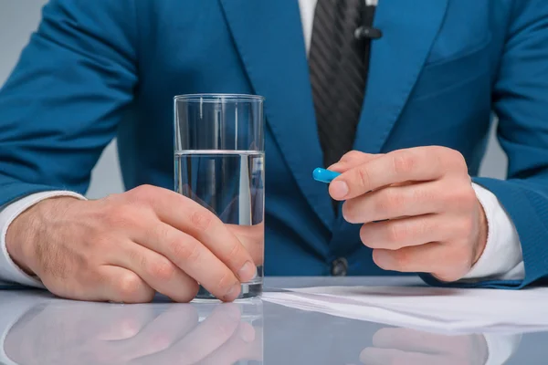 Professional newscaster is about to take a medicine. — Stock Photo, Image