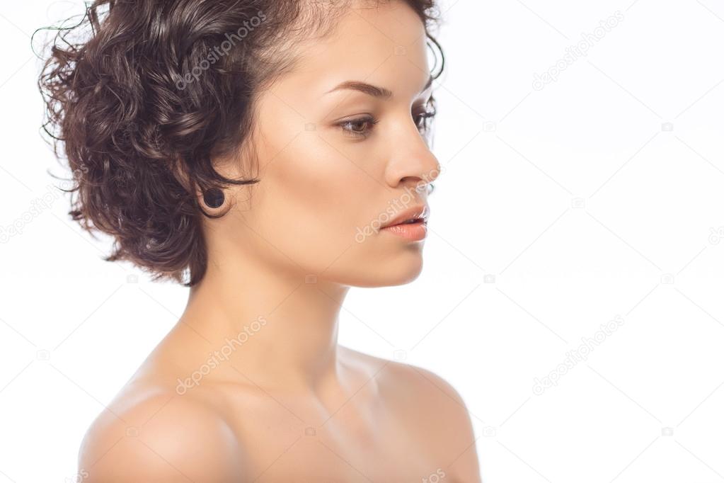Young attractive woman looks aside.