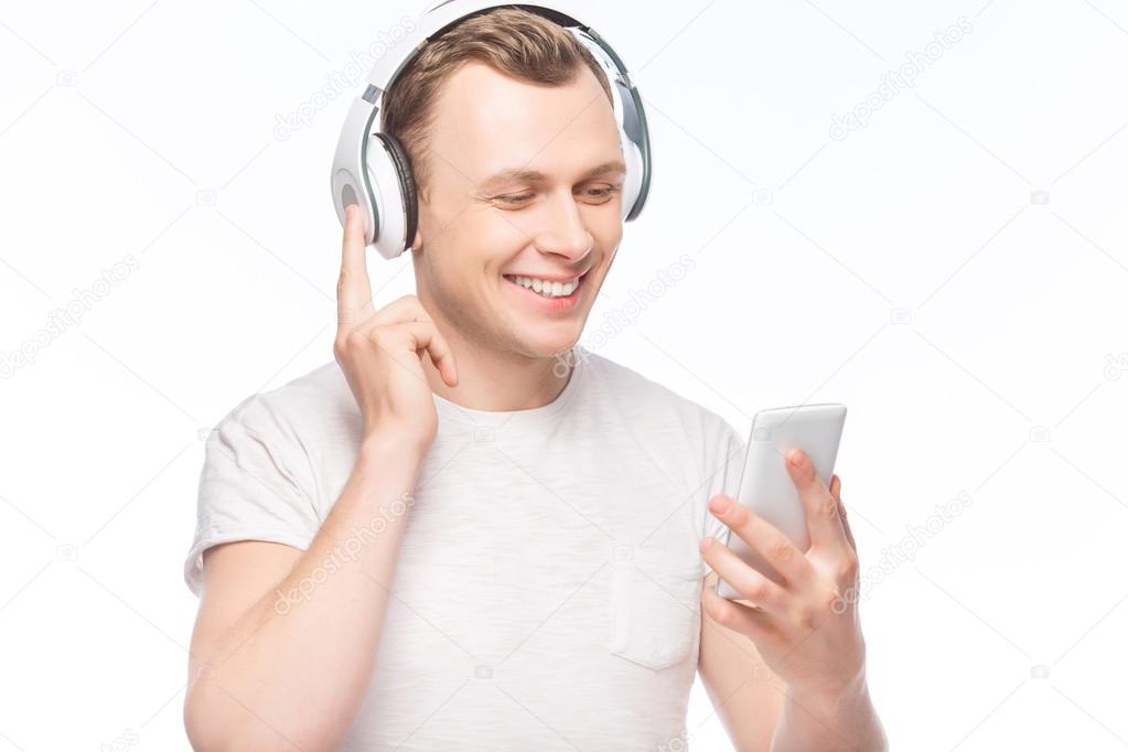 Handsome man with headphones and smartphone.
