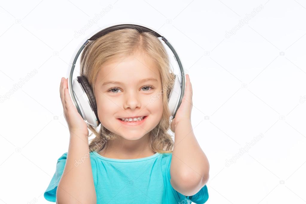 Little girl wearing headphones.