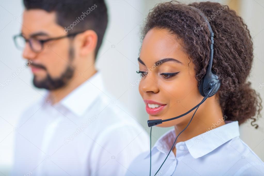 Two office workers are busy at work.