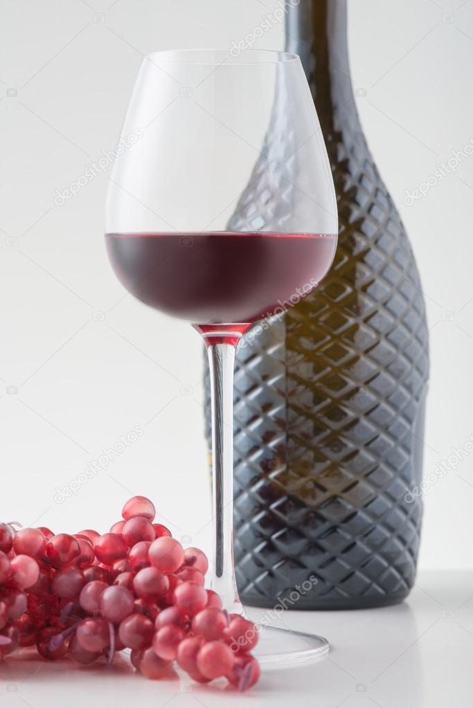 Red wine and sprig of grapes