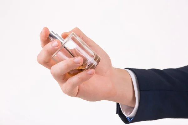 Male hand holding a perfume. — Stock Photo, Image