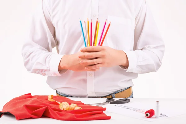 Alfaiate segurando um conjunto de lápis coloridos . — Fotografia de Stock