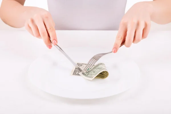 Woman with dinnerware and one dollar. — Stock Photo, Image