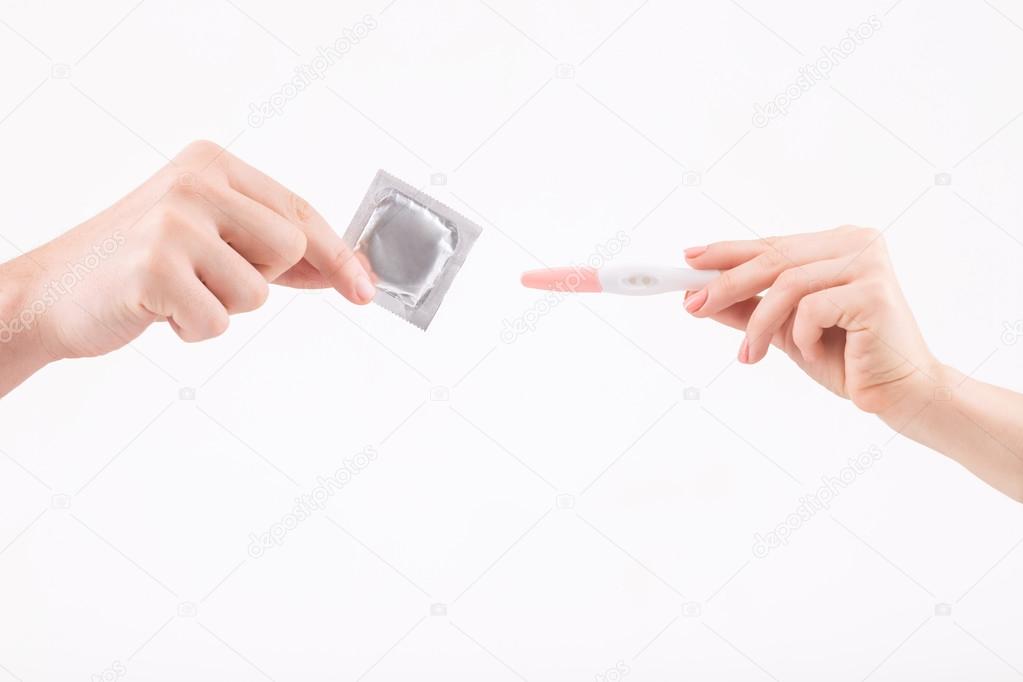 Human hands demonstrating condom