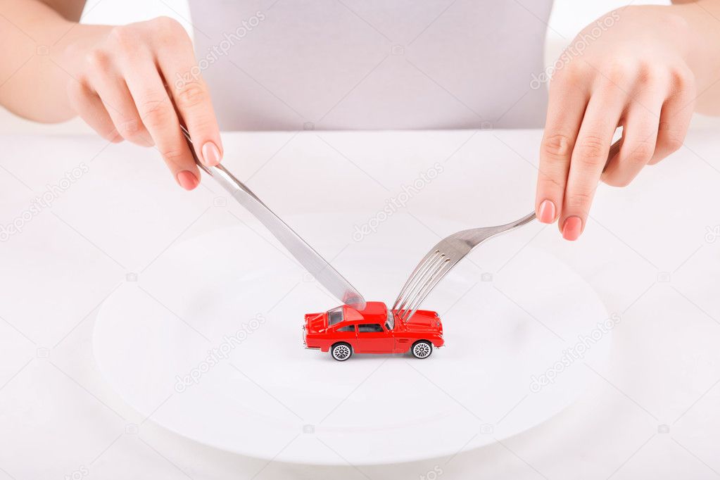 Woman with dinnerware and car model.