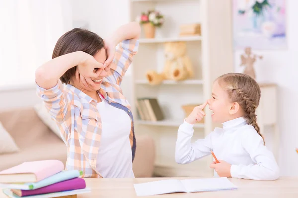 Mom and daughter are making funny faces. — Stock Photo, Image