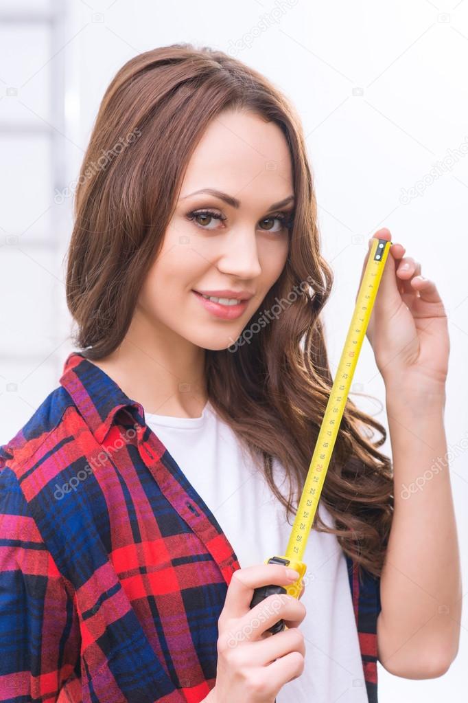 Girl in male role with measure tape.