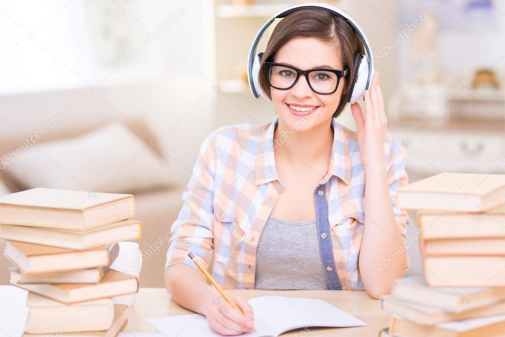 Young female student doing audio exercises.